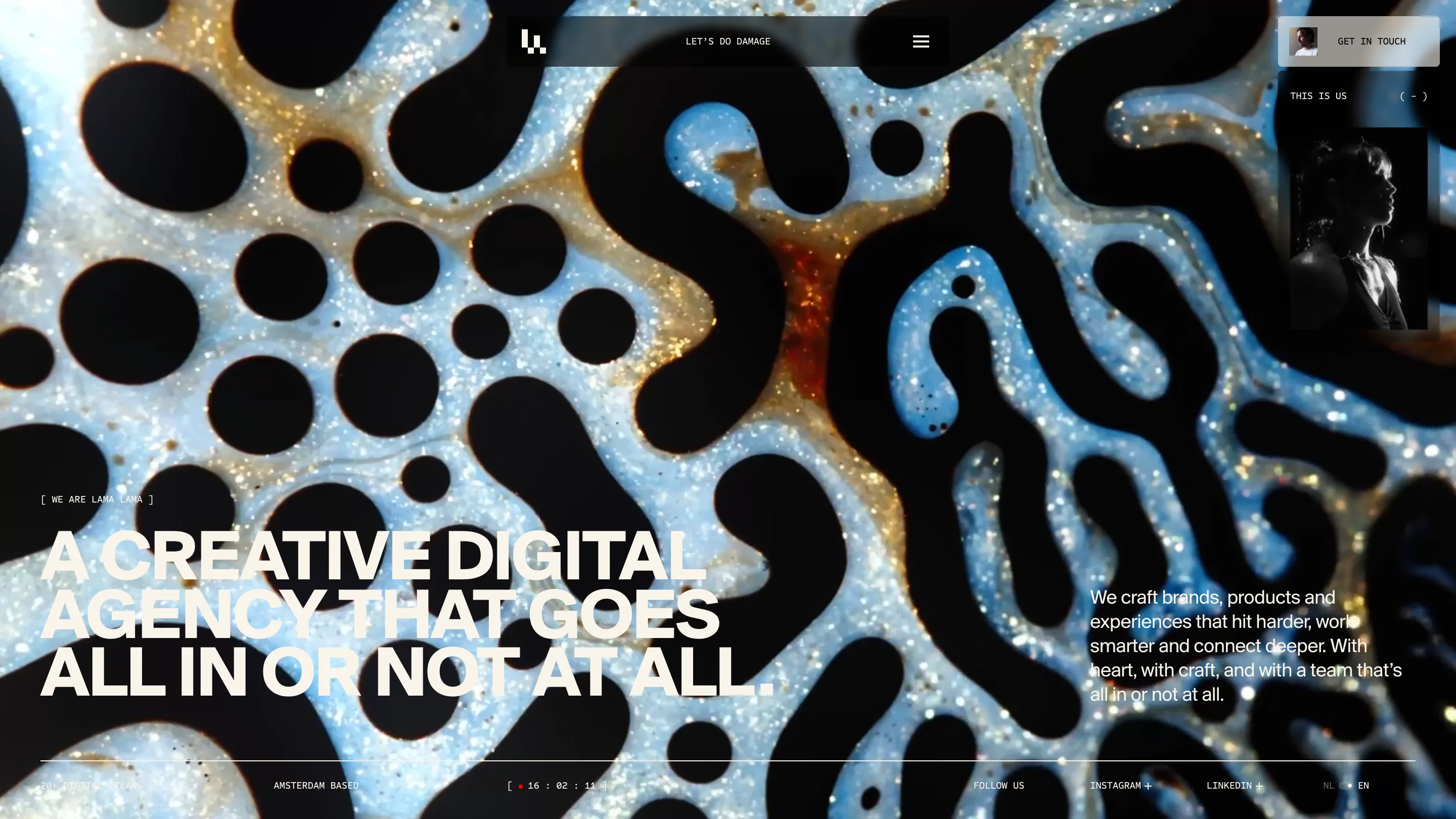 Lama Lama home page: macro photograph of black ink on blue and gold glitter, with the cream headline A CREATIVE DIGITAL AGENCY THAT GOES ALL IN OR NOT AT ALL