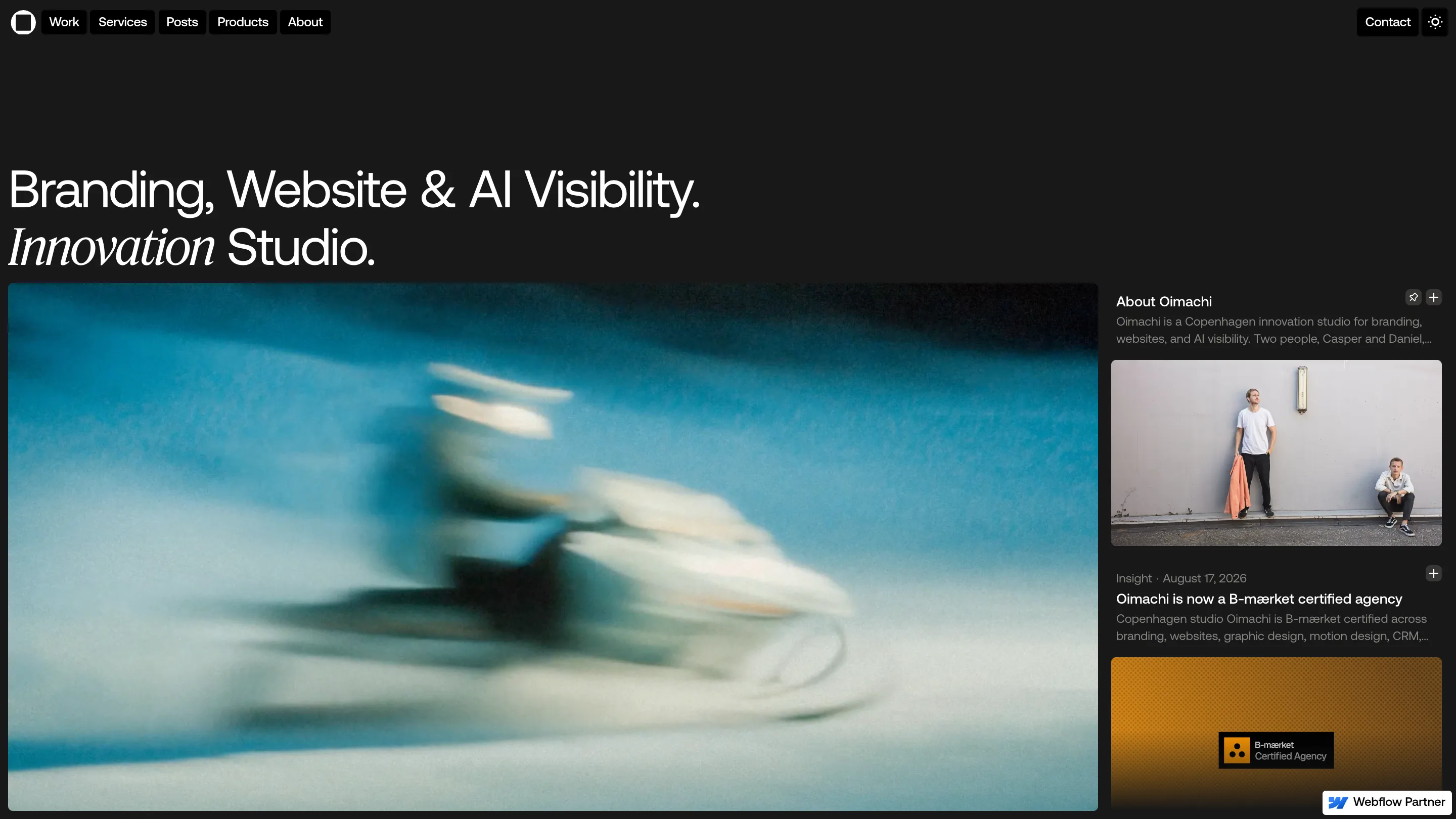 The Oimachi homepage in dark mode, with a sans headline whose word Innovation is set in serif italic, and a blurred blue photograph below