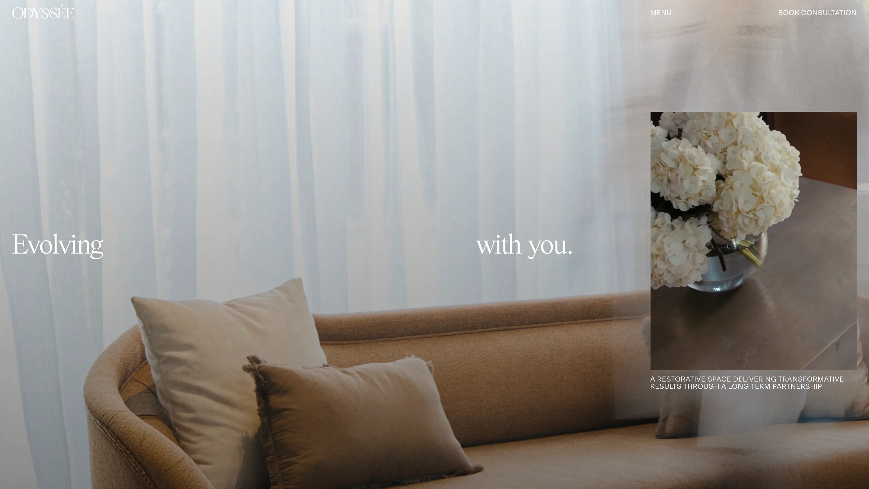 The Odyssée about page: "Evolving" and "with you." split across footage of the clinic's sofa and sheer curtains, with a framed photo of hydrangeas and an uppercase caption on the right