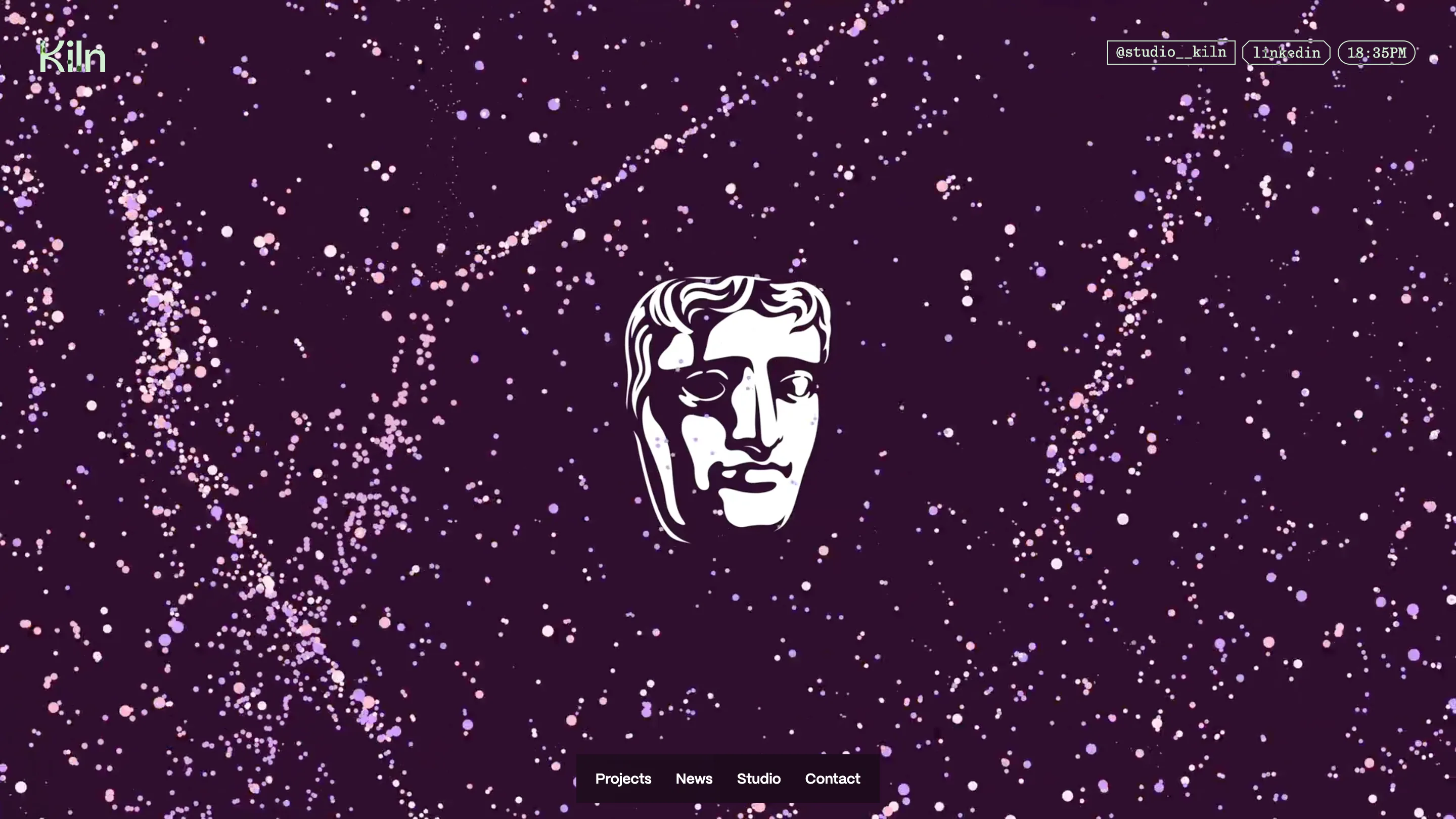 Studio Kiln's BAFTA 2026 case study page: the white BAFTA mask centred on a deep aubergine field scattered with pink and lilac particles