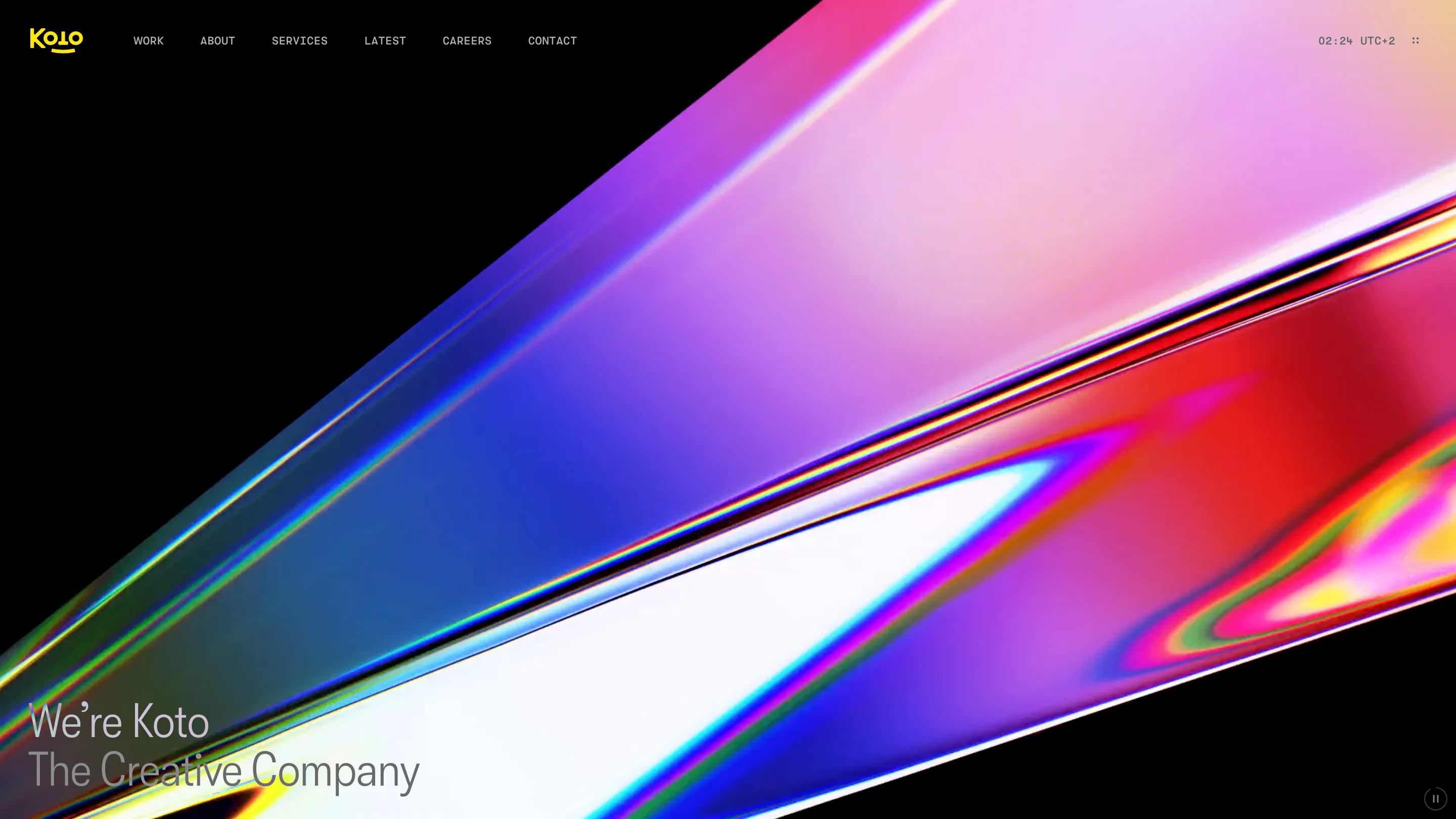 Koto's homepage: a black screen cut by a diagonal prism of magenta, blue and white light, with the line We're Koto, The Creative Company