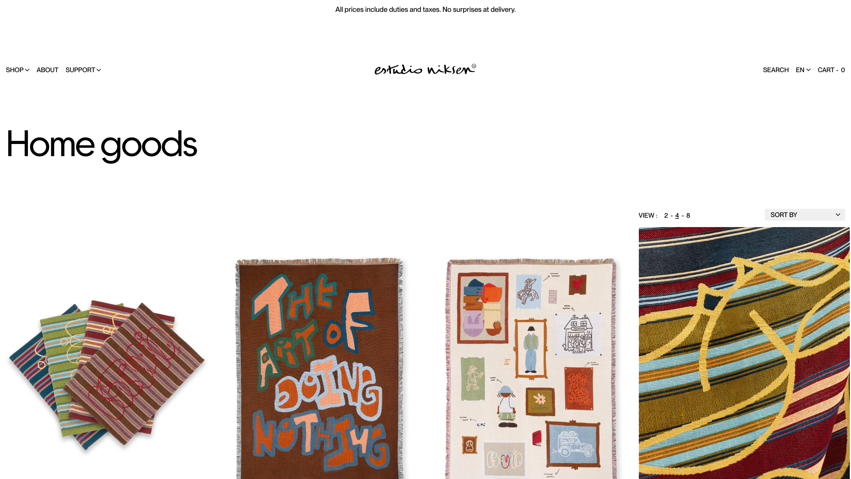 The Home goods collection showing striped woven blankets, one lettered with the words The Art of Doing Nothing