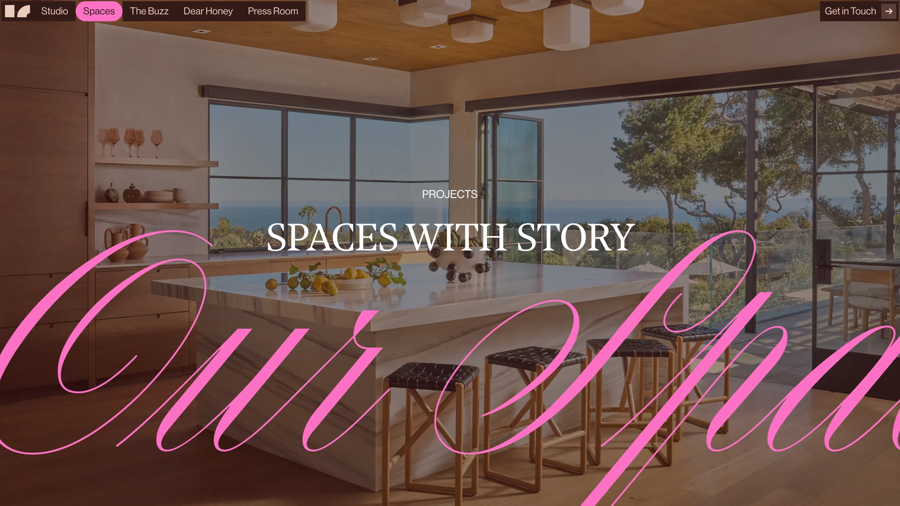 The Spaces page: a kitchen photograph with the words our spaces in giant pink script running off both edges