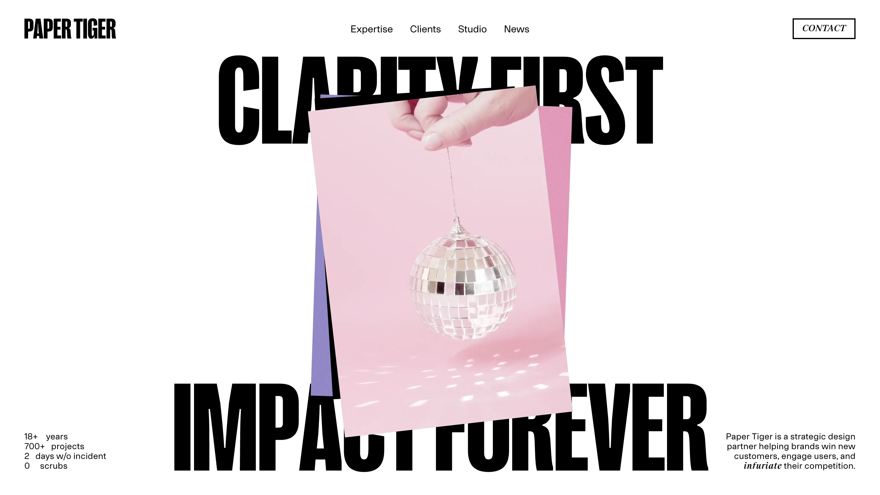 Paper Tiger's home page: the words CLARITY FIRST and IMPACT FOREVER in huge black condensed type wrapping a pink photo of a hand holding a disco ball