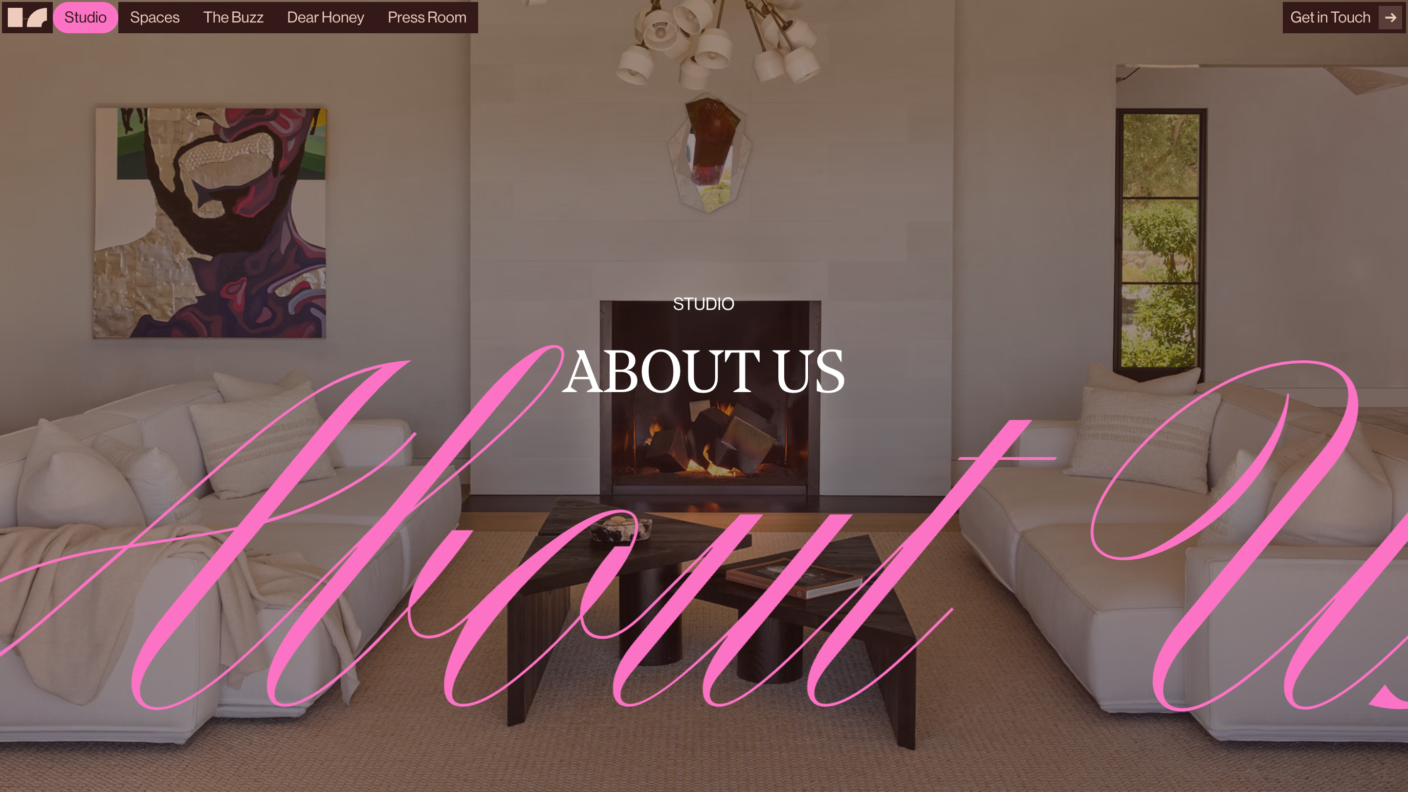 The Studio page of House of Honey: a living room with a lit fireplace, the title ABOUT US in white serif capitals, and pink script crossing the full width